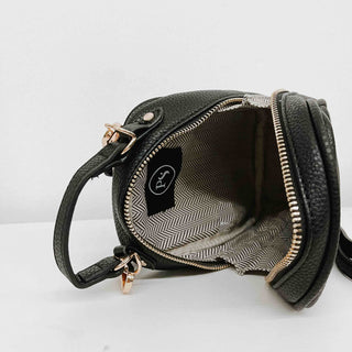 Crossbody bag with handle on top. Black bag and chevron interior with card holder 